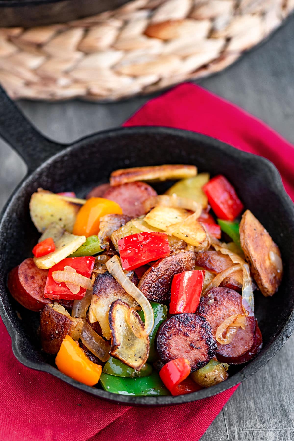 Small cast iron skillet with kielbasa and potatoes recipe in it. Just enough for a single serving. 