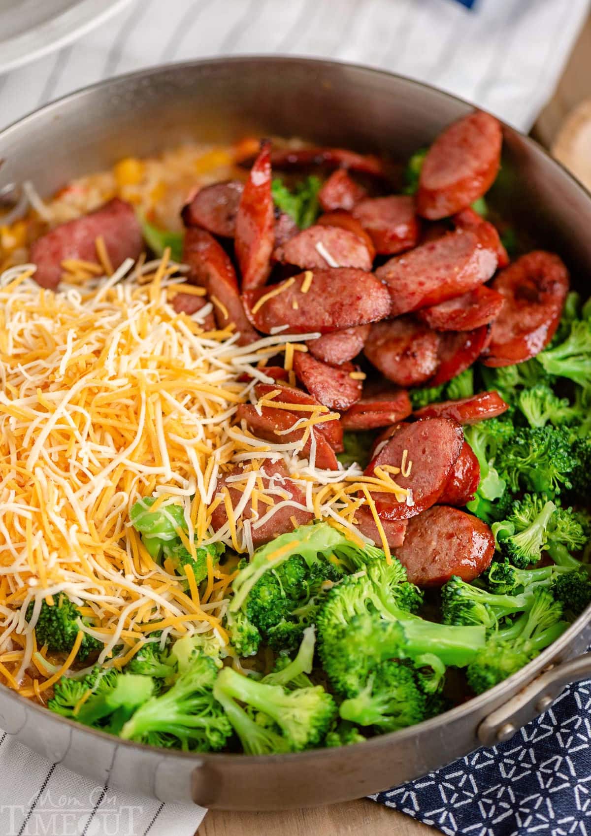 Top down look at kielbasa skillet ingredients in the skillet ready to be stirred in.