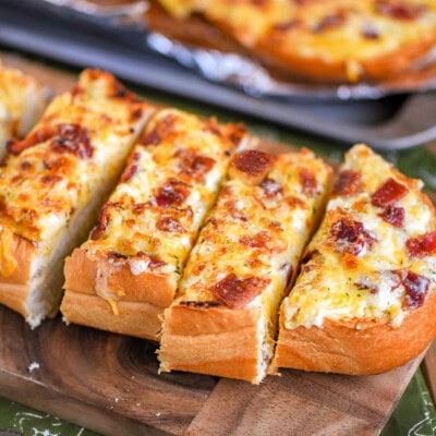 Wide shot of a half loaf of cheese bread cut into slices and ready to serve.