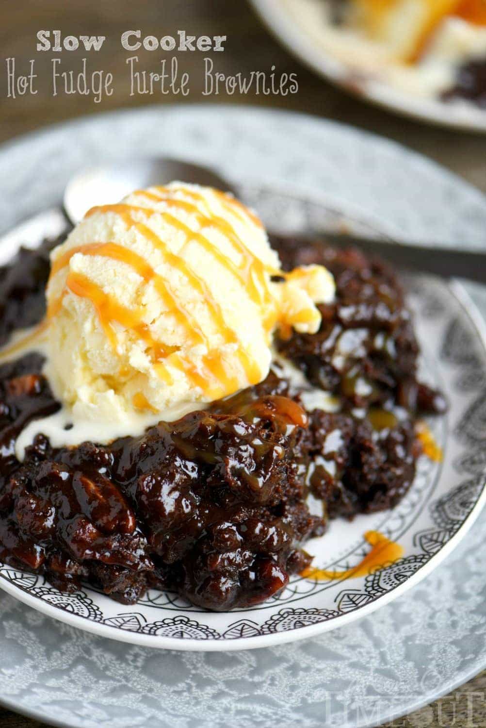 Fabulously gooey and outrageously delicious, these Slow Cooker Hot Fudge Turtle Brownies are going to rock your world! Hot fudge sauce, caramel, pecans, and gooey brownies come together for one irresistible dessert! // Mom On Timeout
