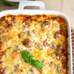 Easy Lazy Day Lasagna recipe baked in white casserole dish topped with fresh basil ready to be served.