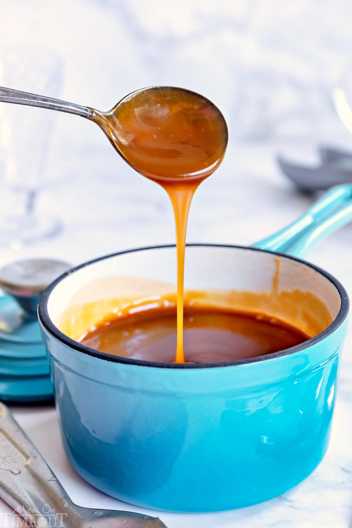 https://www.momontimeout.com/wp-content/uploads/2019/07/easy-caramel-sauce-in-sauce-pan-spoon-drizzle.jpg