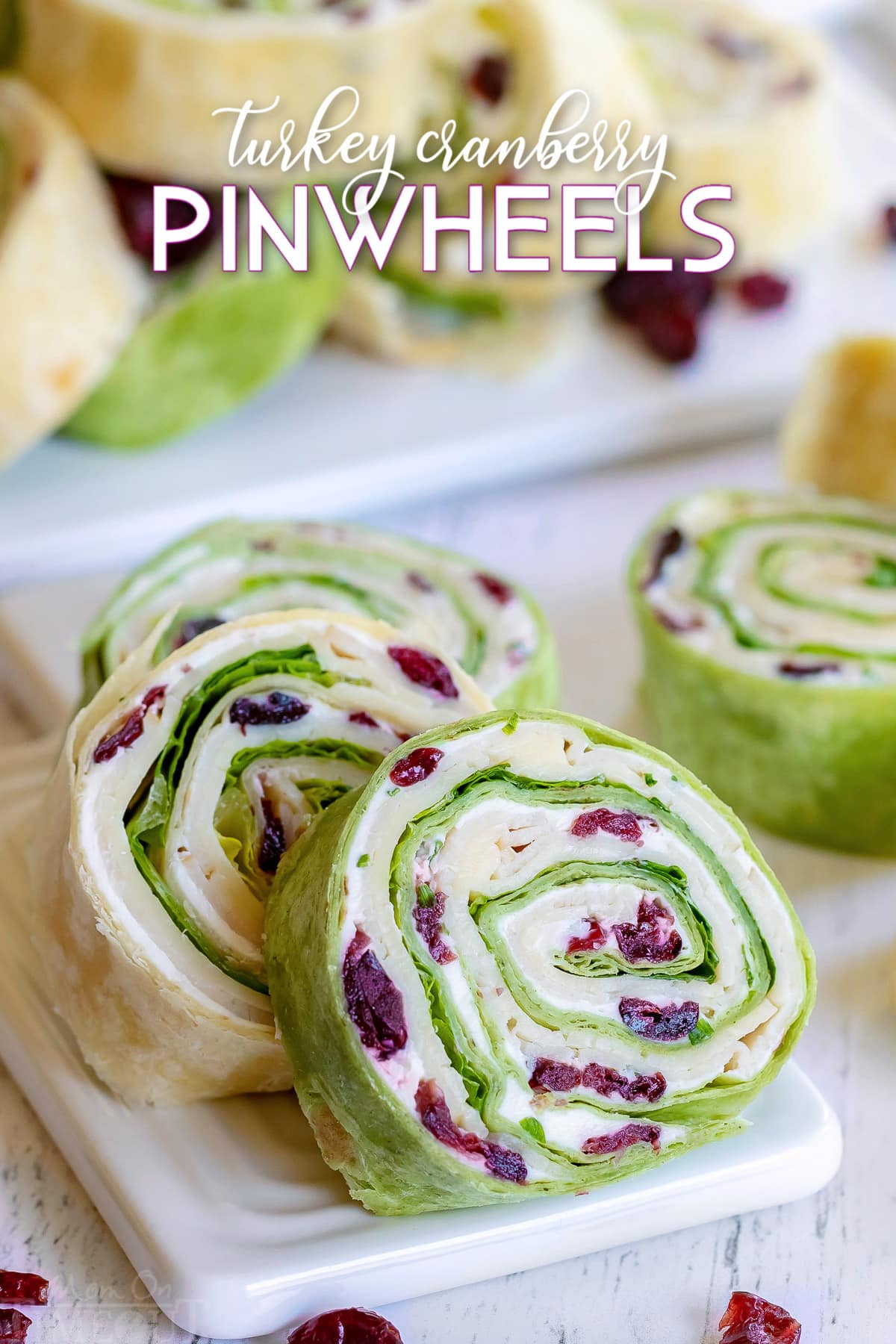 https://www.momontimeout.com/wp-content/uploads/2020/06/turkey-pinwheels-recipe-with-dried-cranberries-on-small-white-cutting-board.jpg