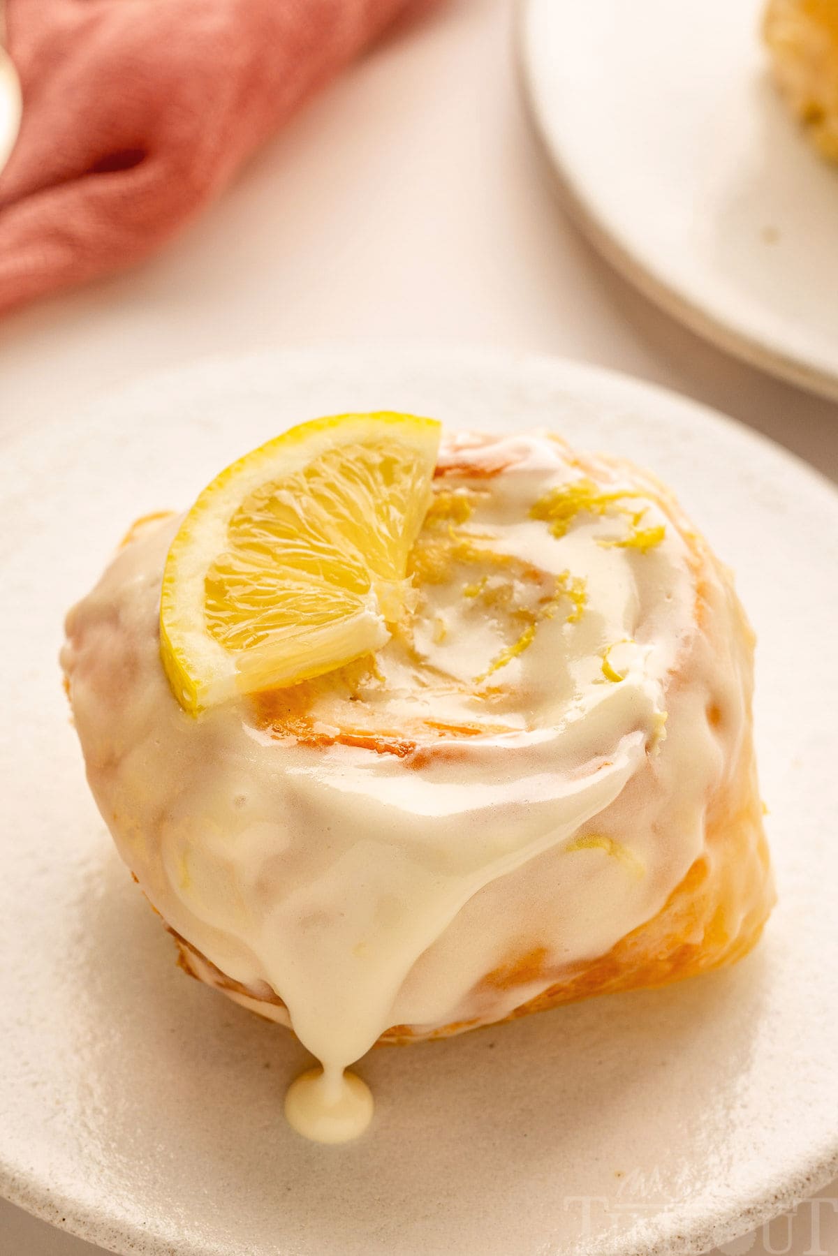 A lemon roll on a white plate.