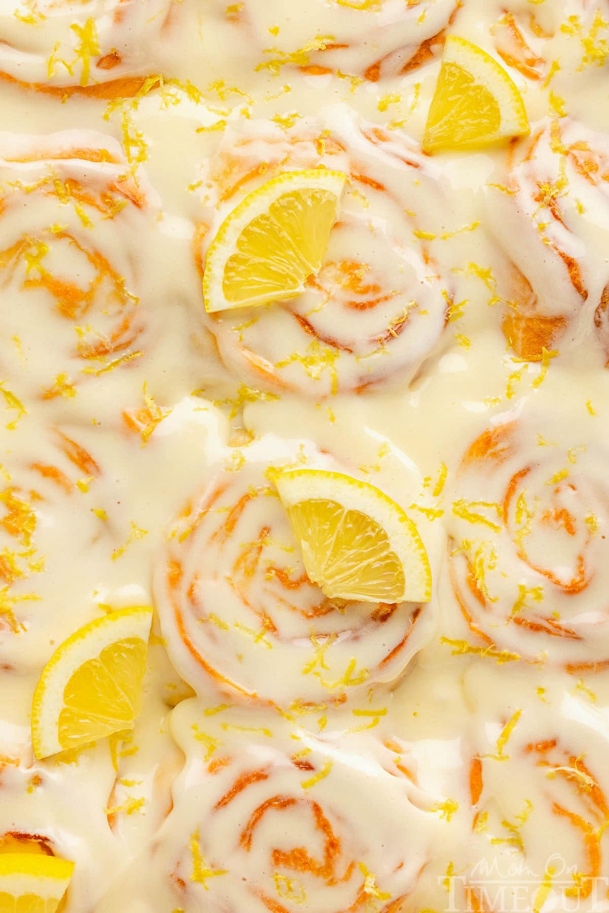A top down view of lemon rolls in a pan.