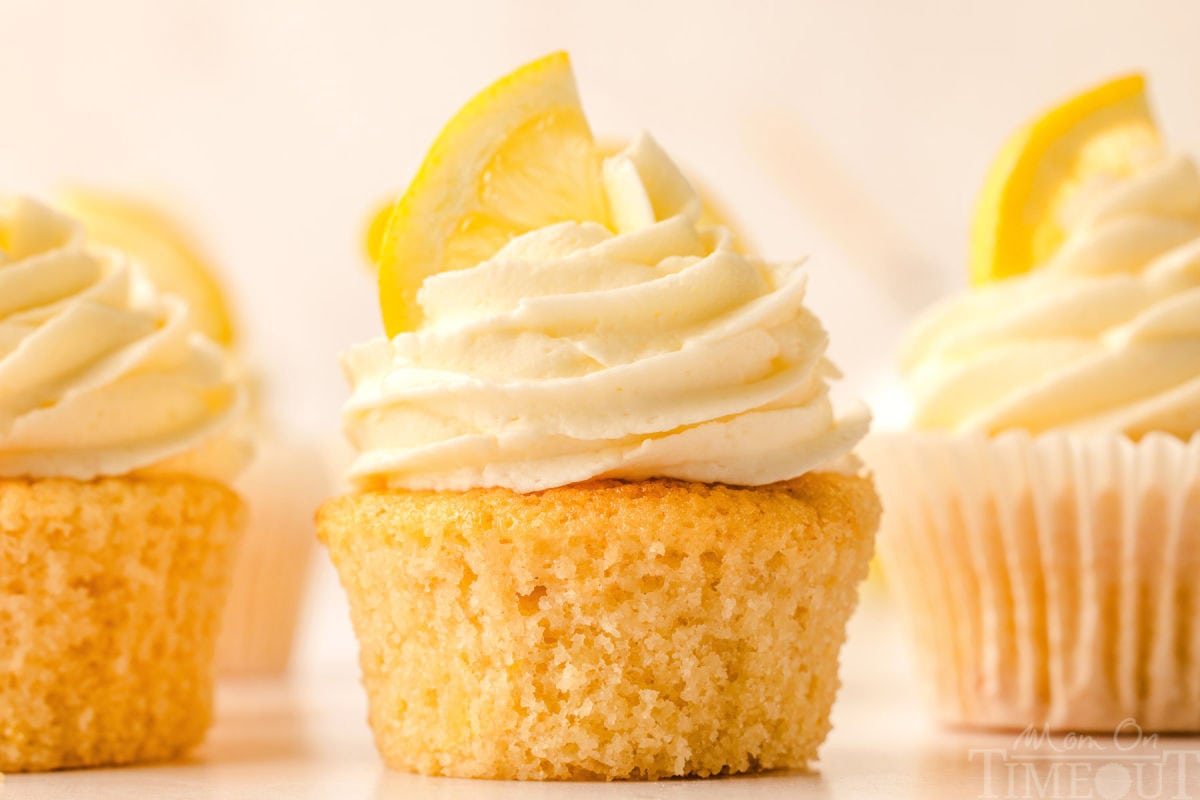 Side view of three lemon cupcakes.