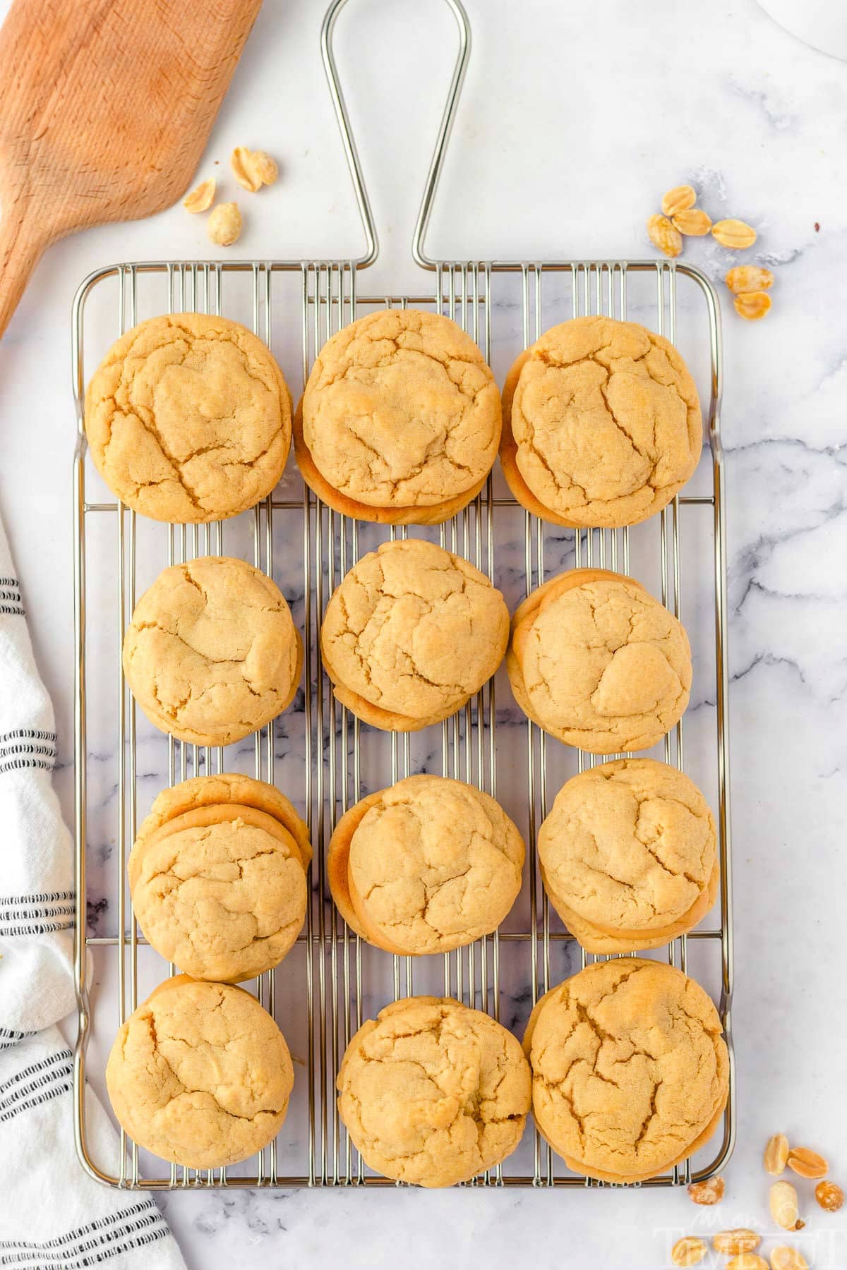 top down view of 12 peanut butter sandwich cookies sitting on a wire cooling rack.