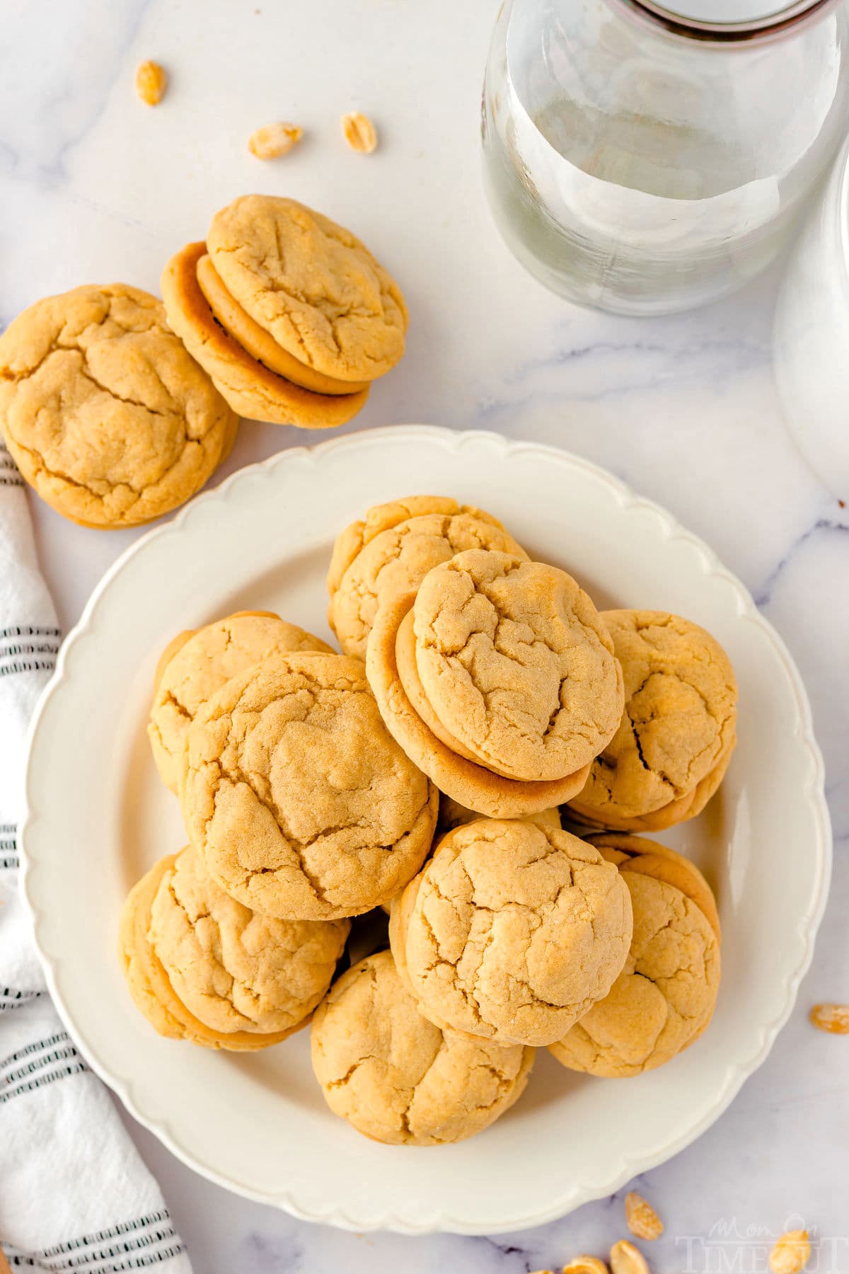 Top down view of peanut butter stuffed cookies on a white round plate.