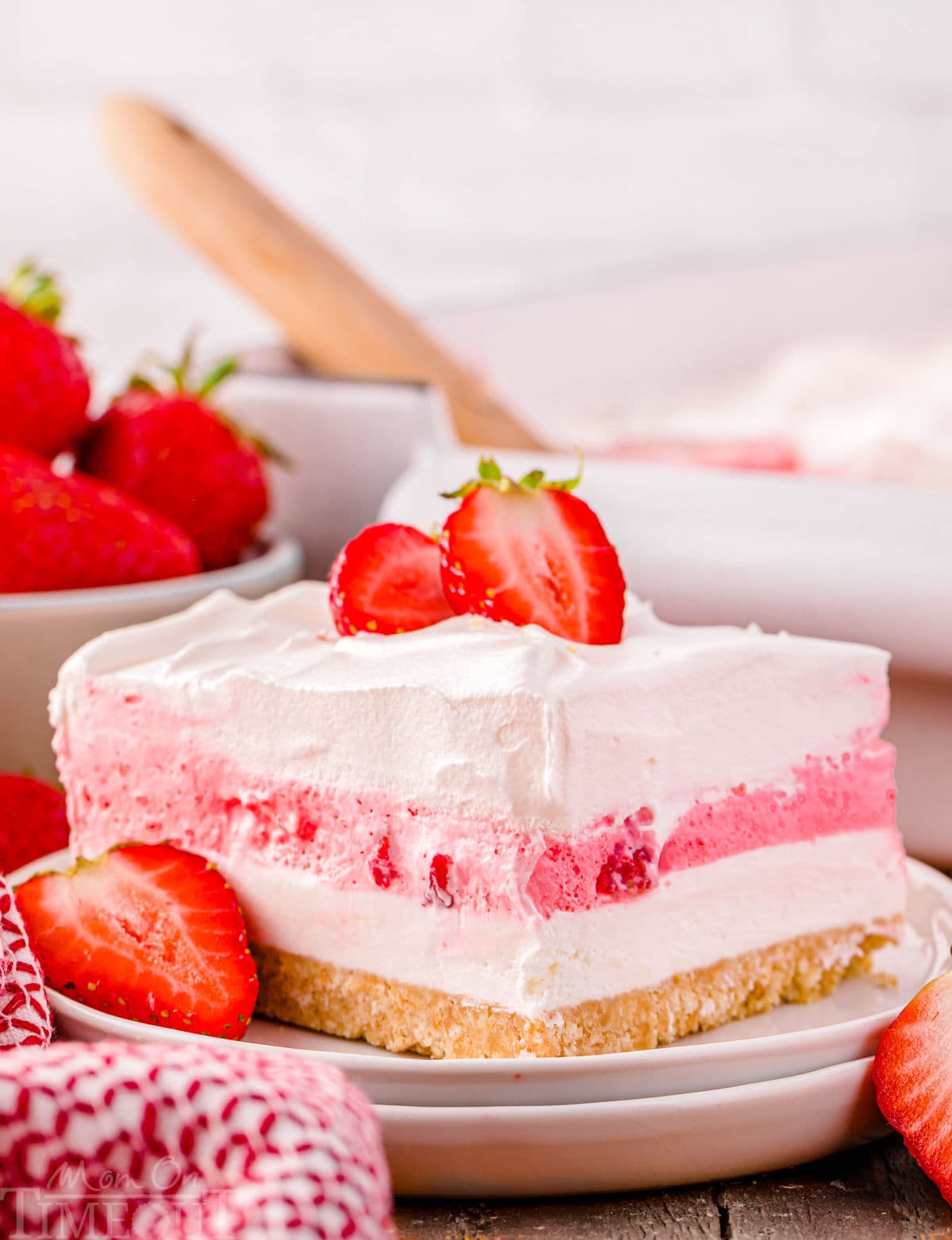 A slice of strawberry lasagna on a white plate.