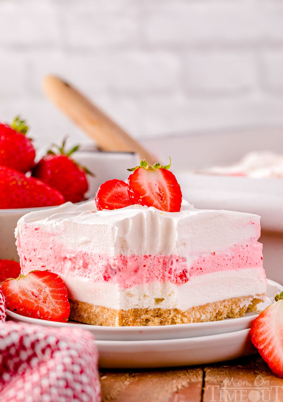 A slice of strawberry lasagna on a white plate.