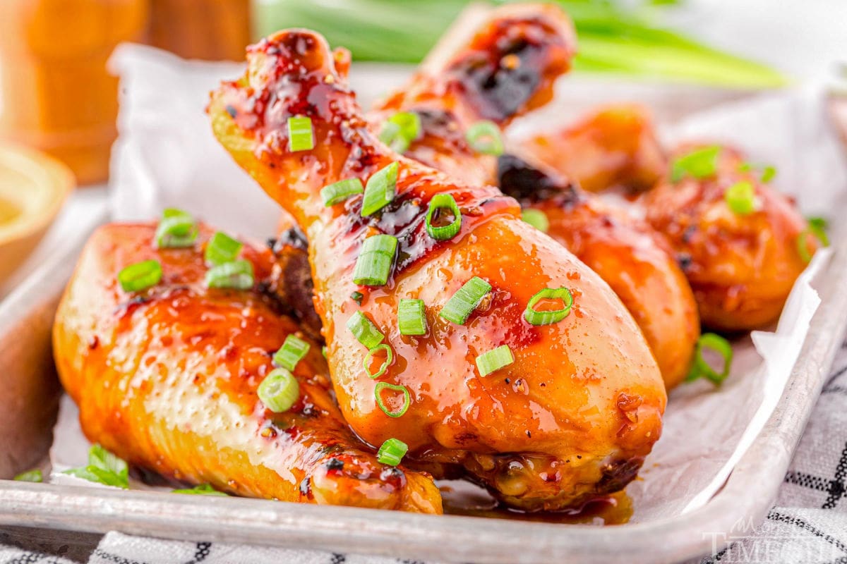 Honey Glazed Chicken drumsticks laying on a tray.