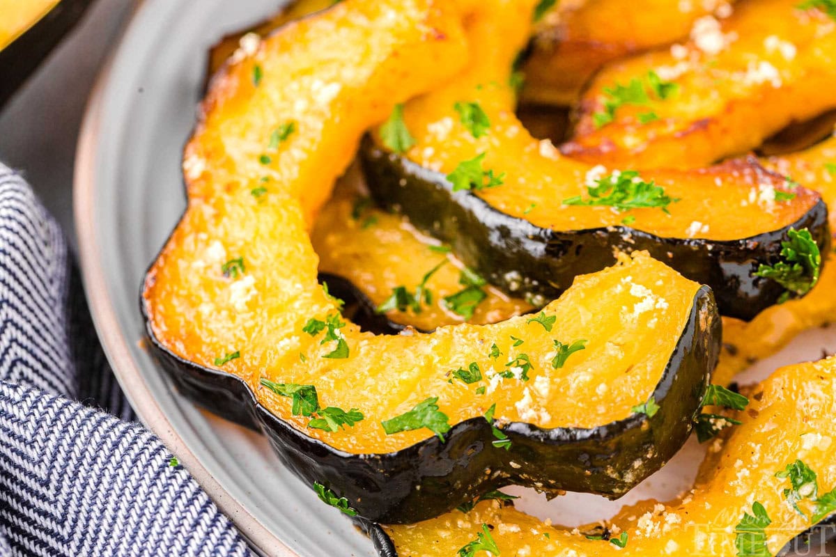 Slices of roasted acorn squash on a plate.