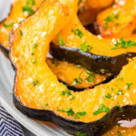 Close up of slices of acorn squash on a plate.