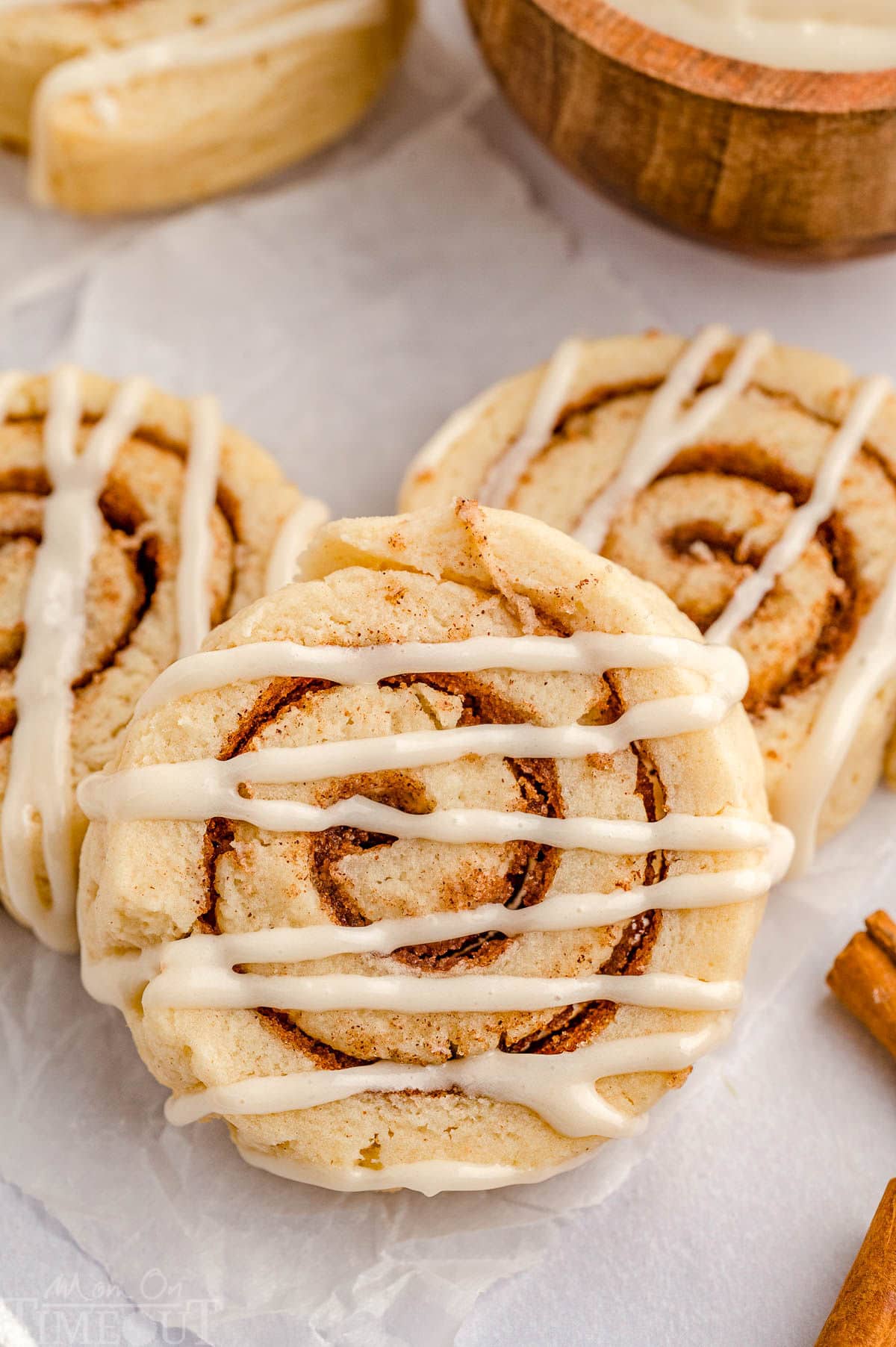 Top down shot of cinnamon roll cookies on parchment paper.