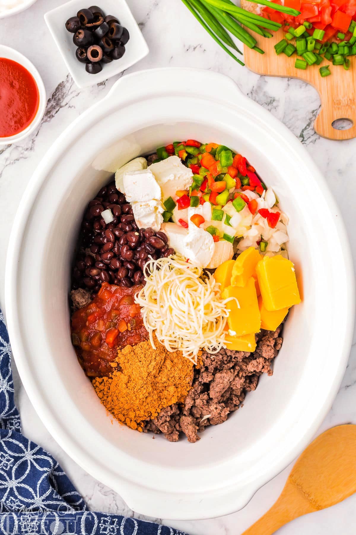 Crockpot taco dip ingredients in a slow cooker.