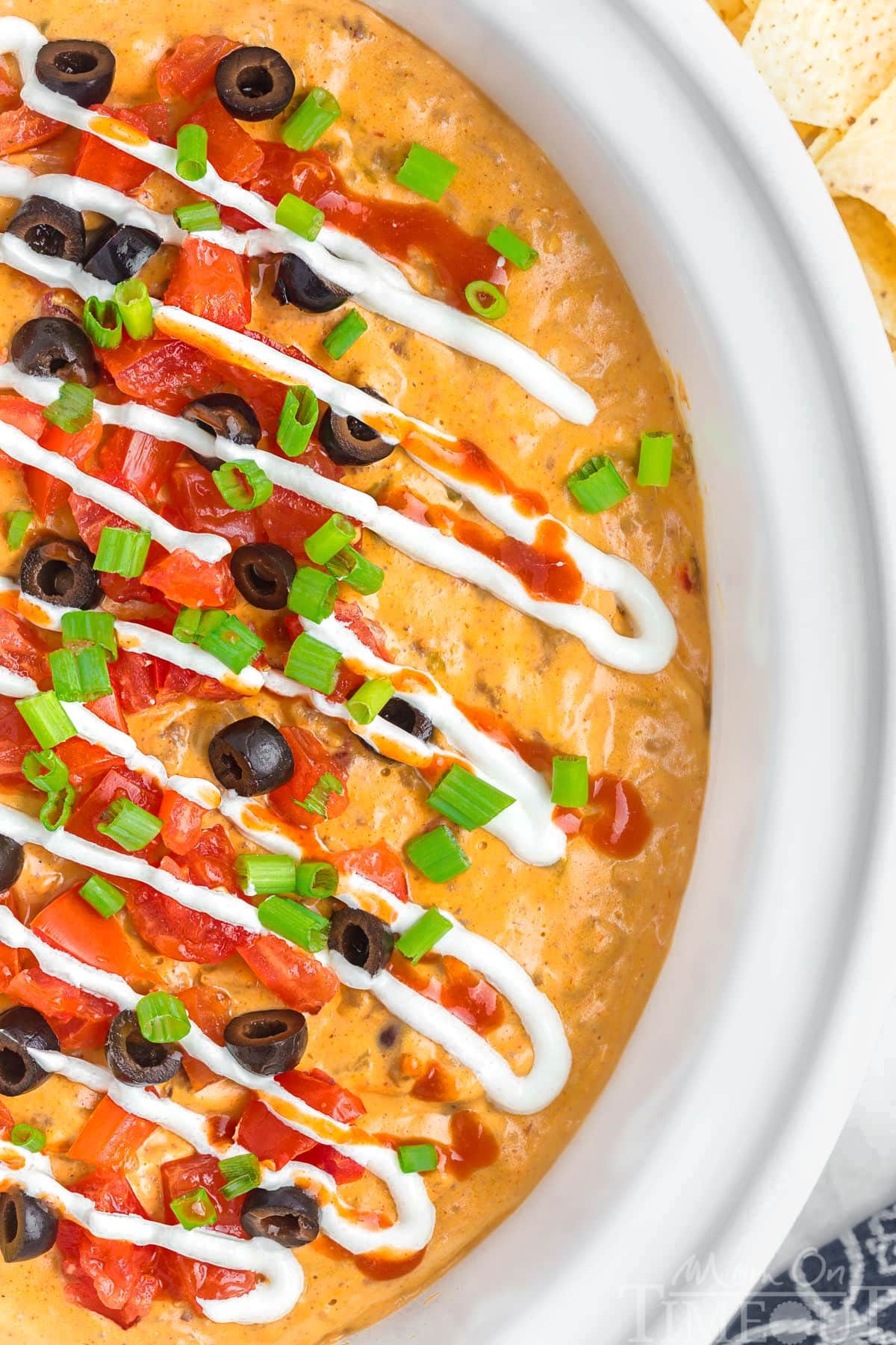 Top down view of crockpot taco dip in a white crockpot insert.