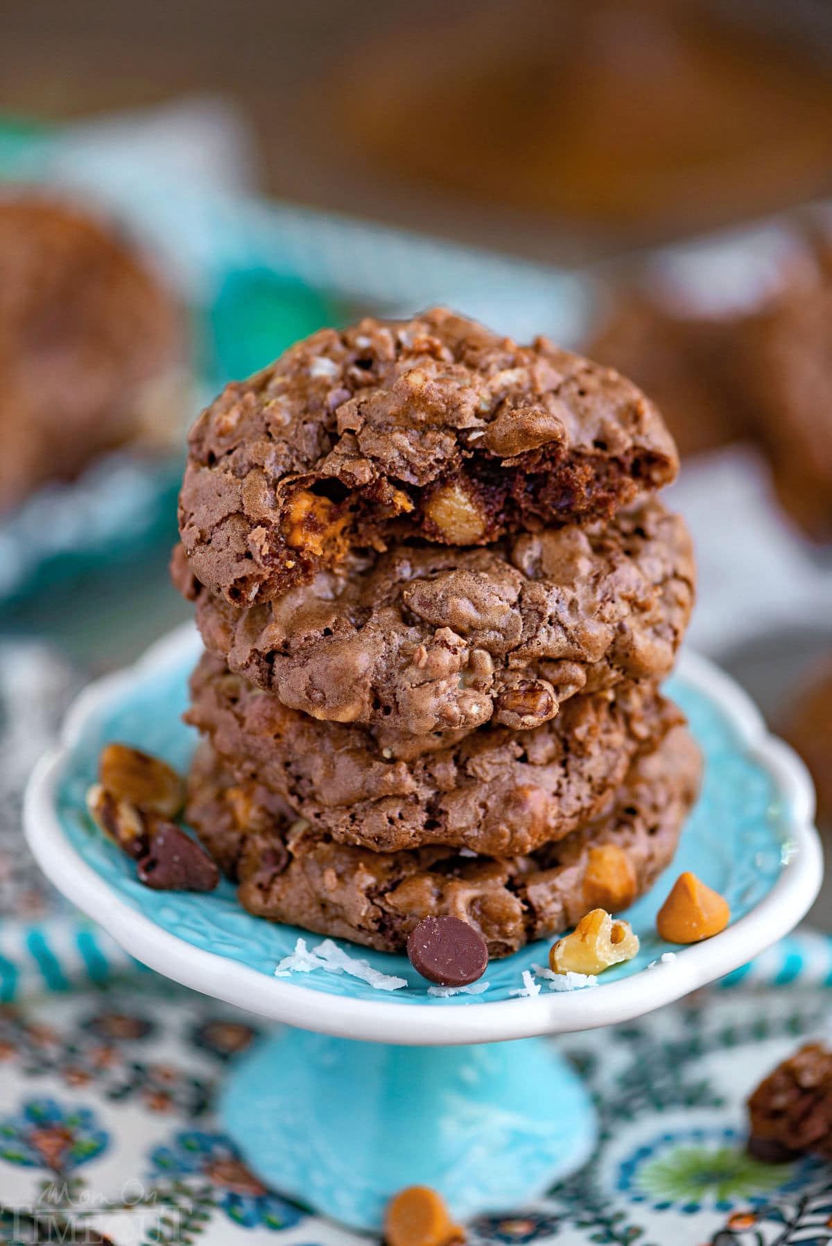 Brownie cookies stacked on a blue stand.