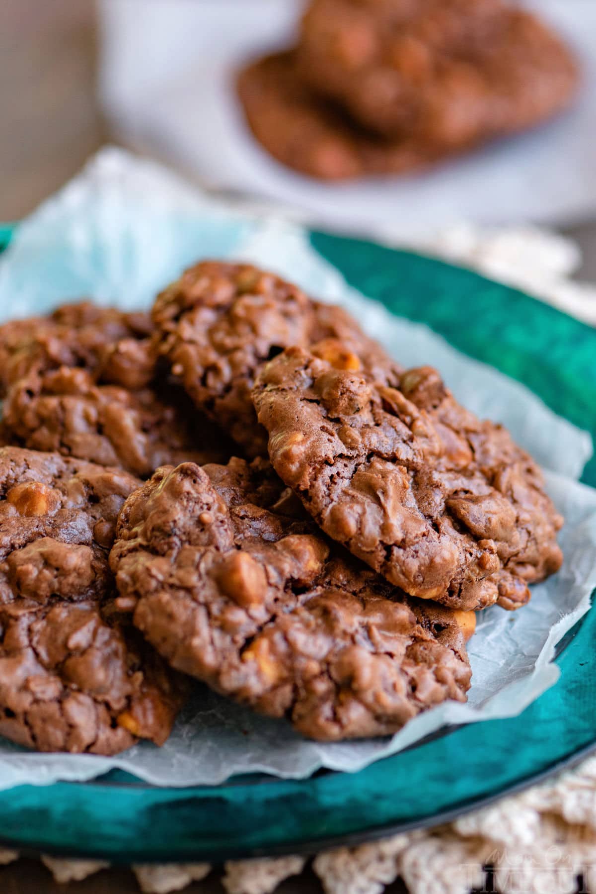 Brownie cookies piled on a green plate.