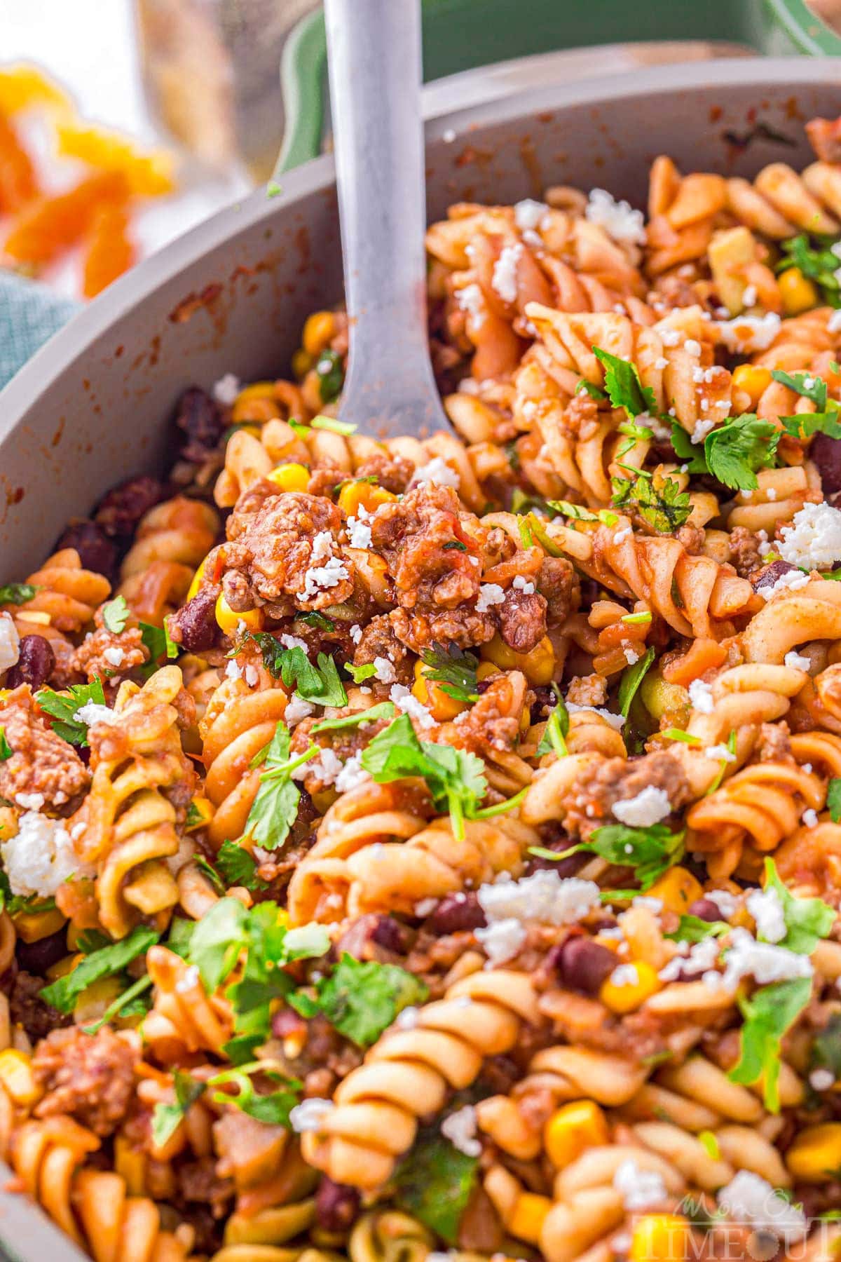 Close up look at taco pasta being scooped from the skillet.