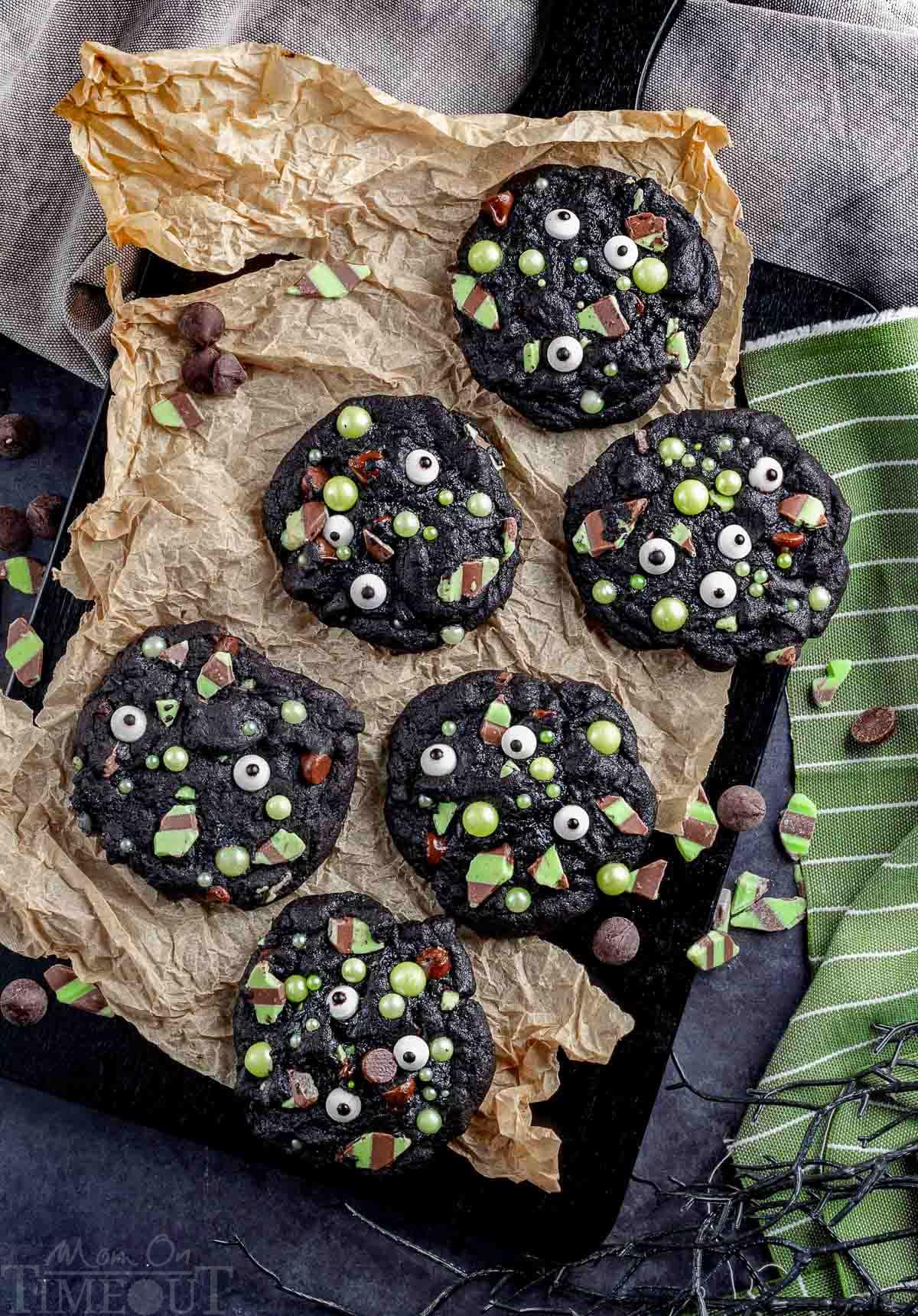 Monster Halloween Cookies laid out on a piece of brown parchment paper.