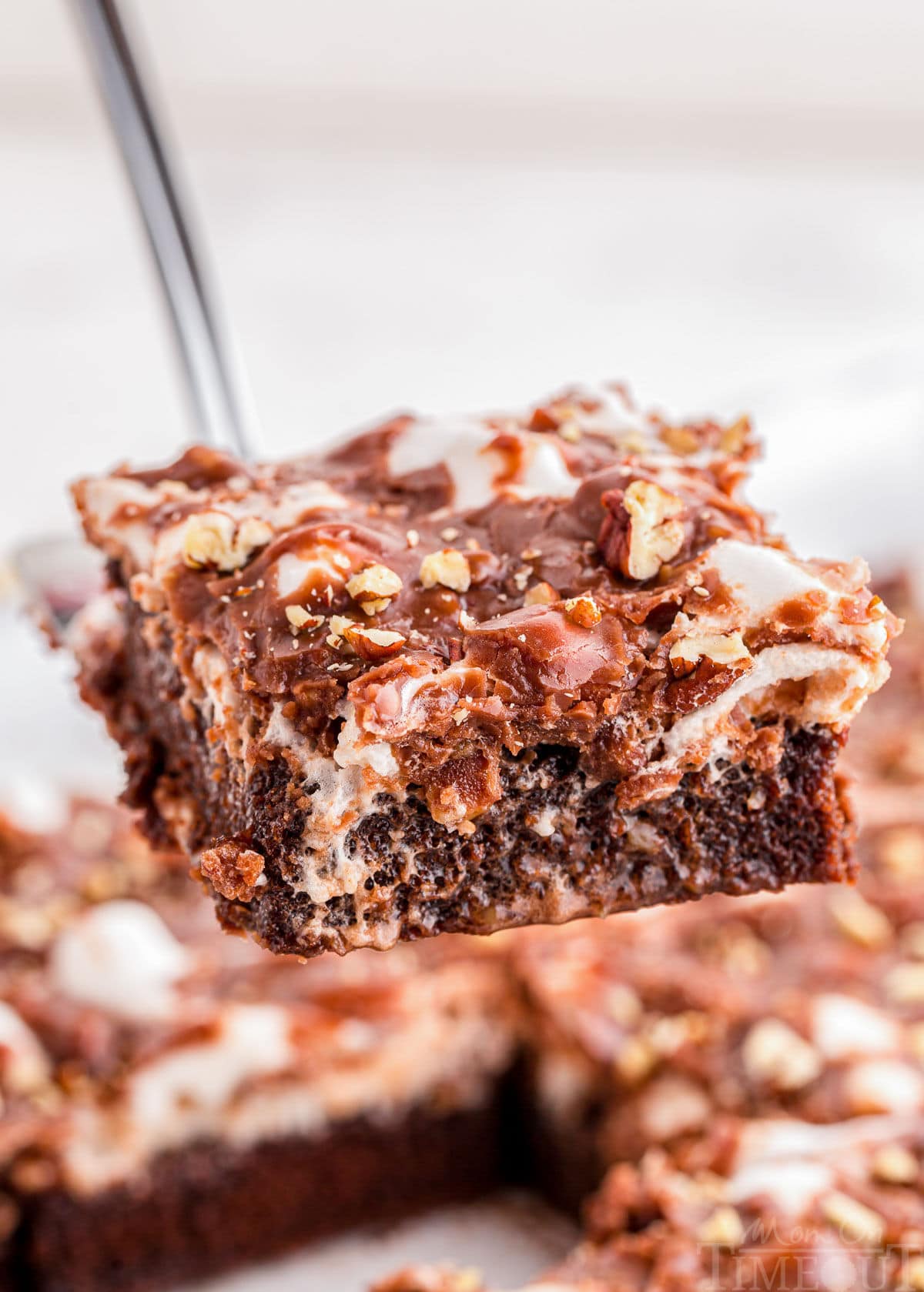 Slice of Mississippi Mud Cake being lifted away from the rest of the cake with a server.