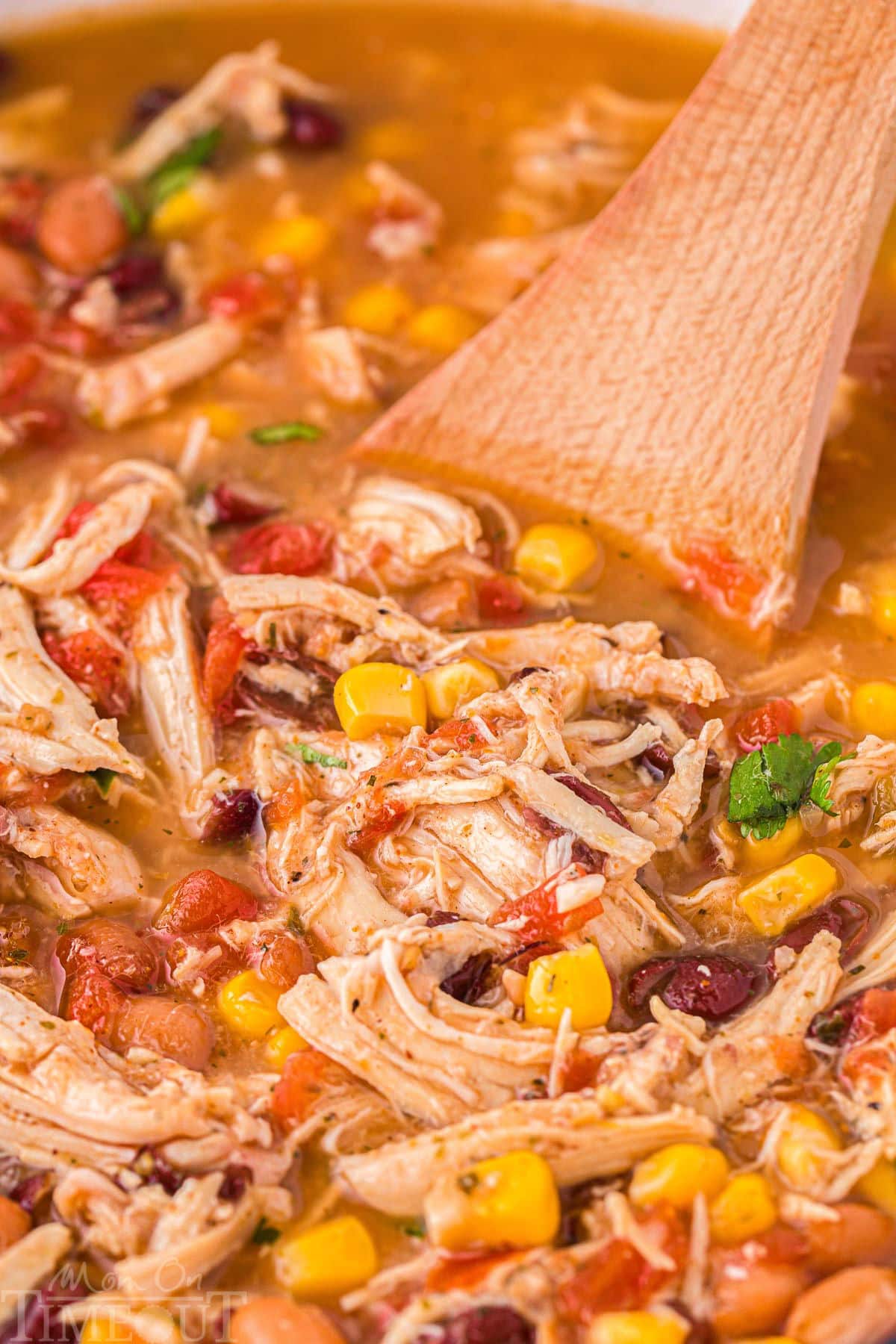 A wood spoon in the chicken taco soup.