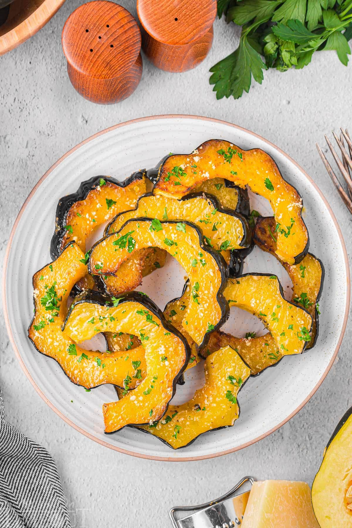 Top down view of a plate of roast acorn squash ready to be enjoyed.