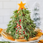 Christmas Tree Cheese Ball on a white plate with crackers.