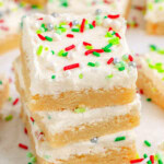 Three Christmas Sugar Cookie Bars in a stack with more bars in the background.