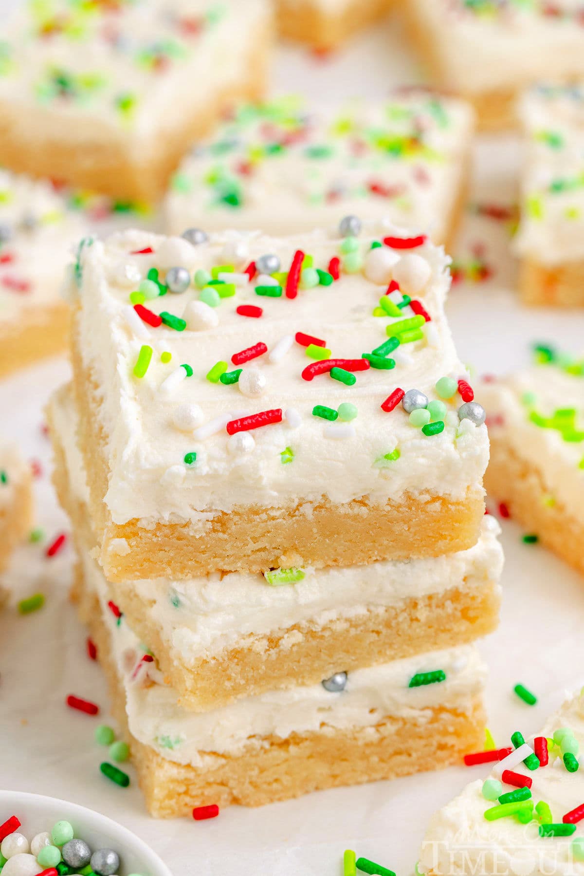 Three Christmas Sugar Cookie Bars in a stack with more bars in the background.