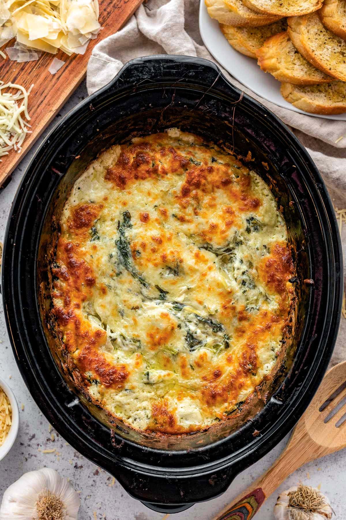 Top down view of spinach artichoke dip in crockpot.