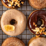 Shot of banana donuts topped with glazes and cinnamon sugar.