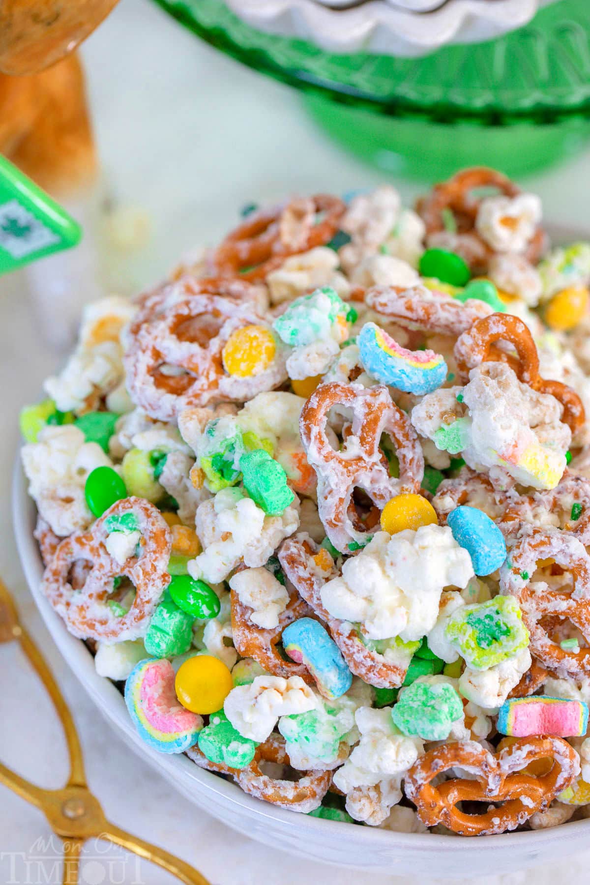 Close up look at Leprechaun Bait in white bowl with green cake stand in background.